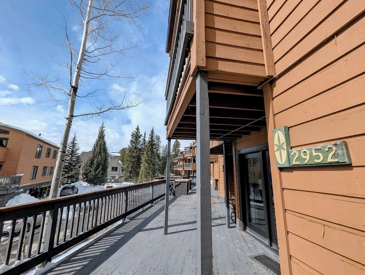 Un edificio de madera con balcón y un cartel que muestra el número 2952.