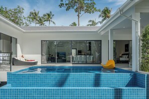 A modern house with a swimming pool, large windows, and a patio area. - Osho Villas Koh Phangan  (Ko Pha-ngan)