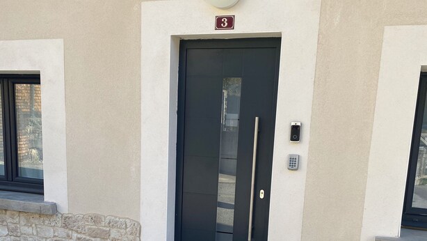A building entrance with a dark door, a number plate '3', and a small window to the left. - ALBARINE la Source river/lakes, waterfalls and mountains, plastics processing business (Arbent)