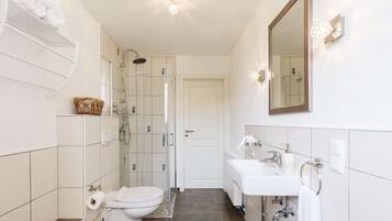 Ein modernes Badezimmer mit Dusche, Toilette und Waschbecken.