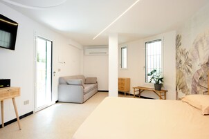 Family Triple Room, Patio | Desk, laptop workspace, free WiFi