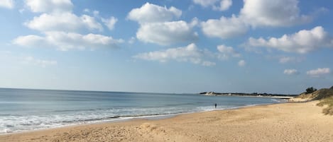 Enjoy a serene beach experience with calm waters and a wide sandy shore.