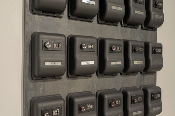 A wall with multiple control panels, each labeled with a number from 112 to 134.