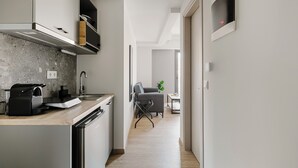A modern kitchen with a built-in dishwasher, a coffee machine, and a granite countertop. - B48 Athens Dafni (Dafni-Ymittos)