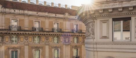 A multi-story building with classical architectural details, including ornate window frames and decorative moldings.