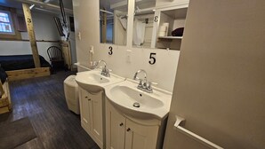 A bathroom with two sinks, a mirror, and a shower area. - Shoreline Estates - Glamping B (Confluence)