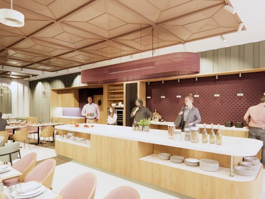 Ein modernes Restaurant mit einer zentralen Theke, Esstischen und Stühlen.