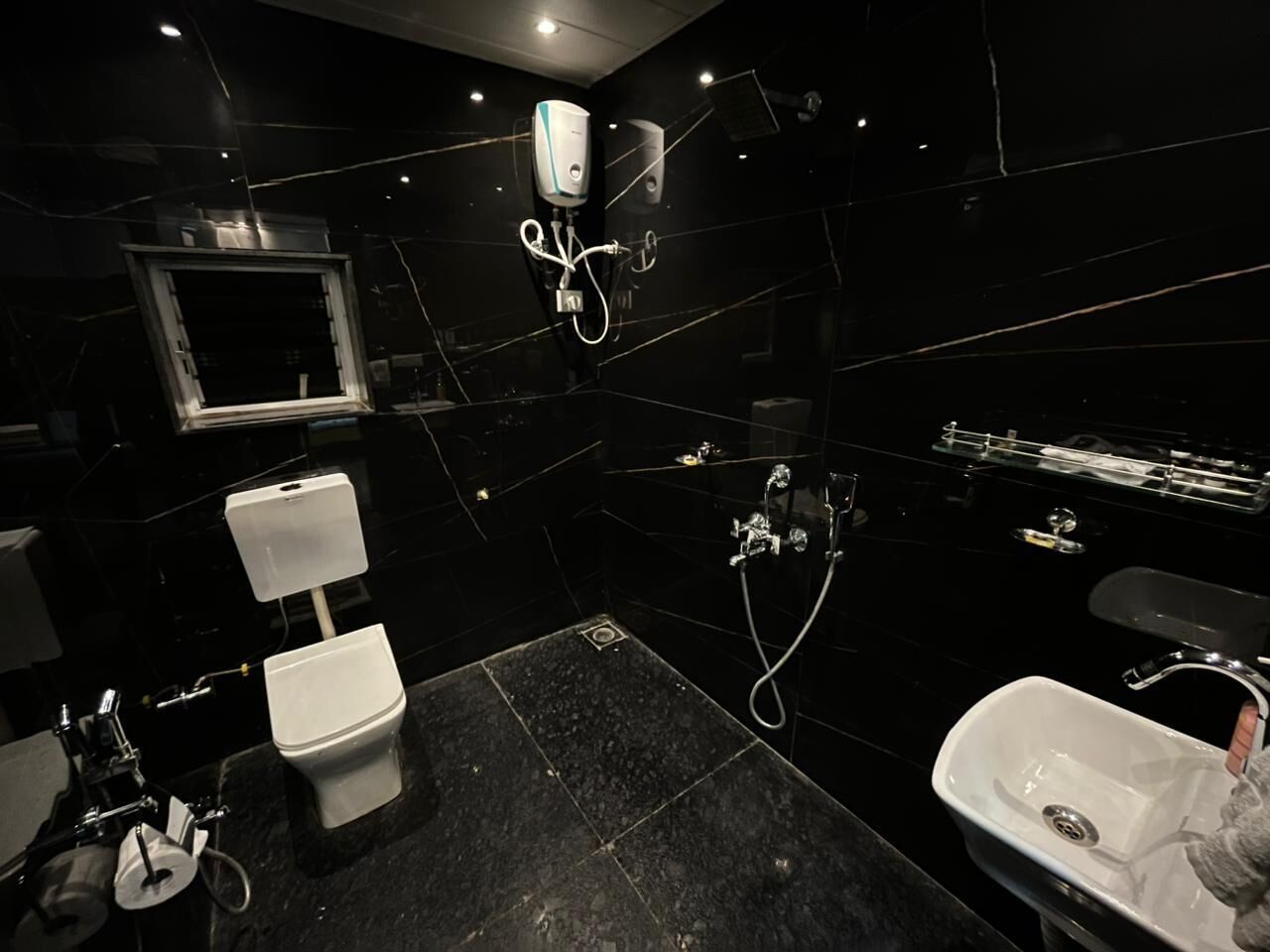 A modern bathroom with a toilet, sink, and shower.