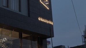 A building with illuminated signage reading "the luxury stay".