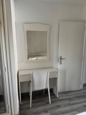 A room with a white desk, a chair, and a closed door. - Las Americas 1-bed Apt, Sleeps 5, Pool, Parking (Arona)