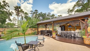 A backyard with a swimming pool, patio furniture, a barbecue area, and a covered seating area. - Outdoor Kitchen & Hot Tub: Tranquil Home in Humble (Humble)