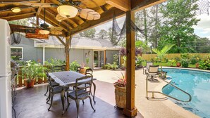 An outdoor patio with a pool, wooden ceiling, and potted plants. - Outdoor Kitchen & Hot Tub: Tranquil Home in Humble (Humble)