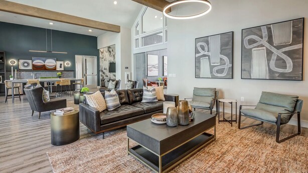 A spacious living room with a modern sofa, a coffee table, and a dining area in the background. - Landing | Modern 1BD, Gym, Pool (Fate)