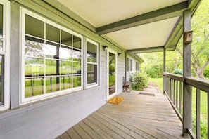 Step outside to a serene view of the surrounding landscape from this inviting porch.