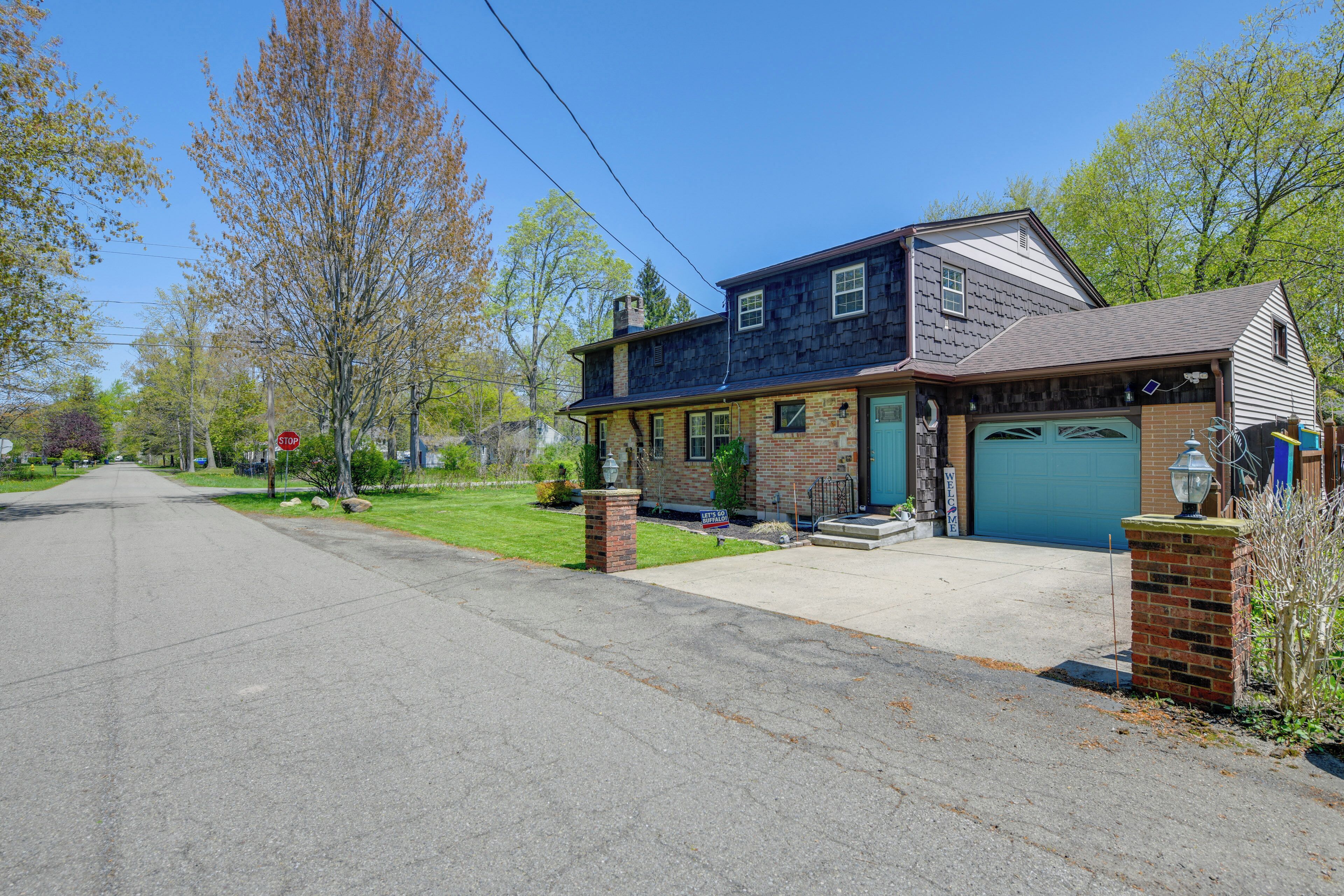 A two-story house with a garage, a front yard, and a street view.