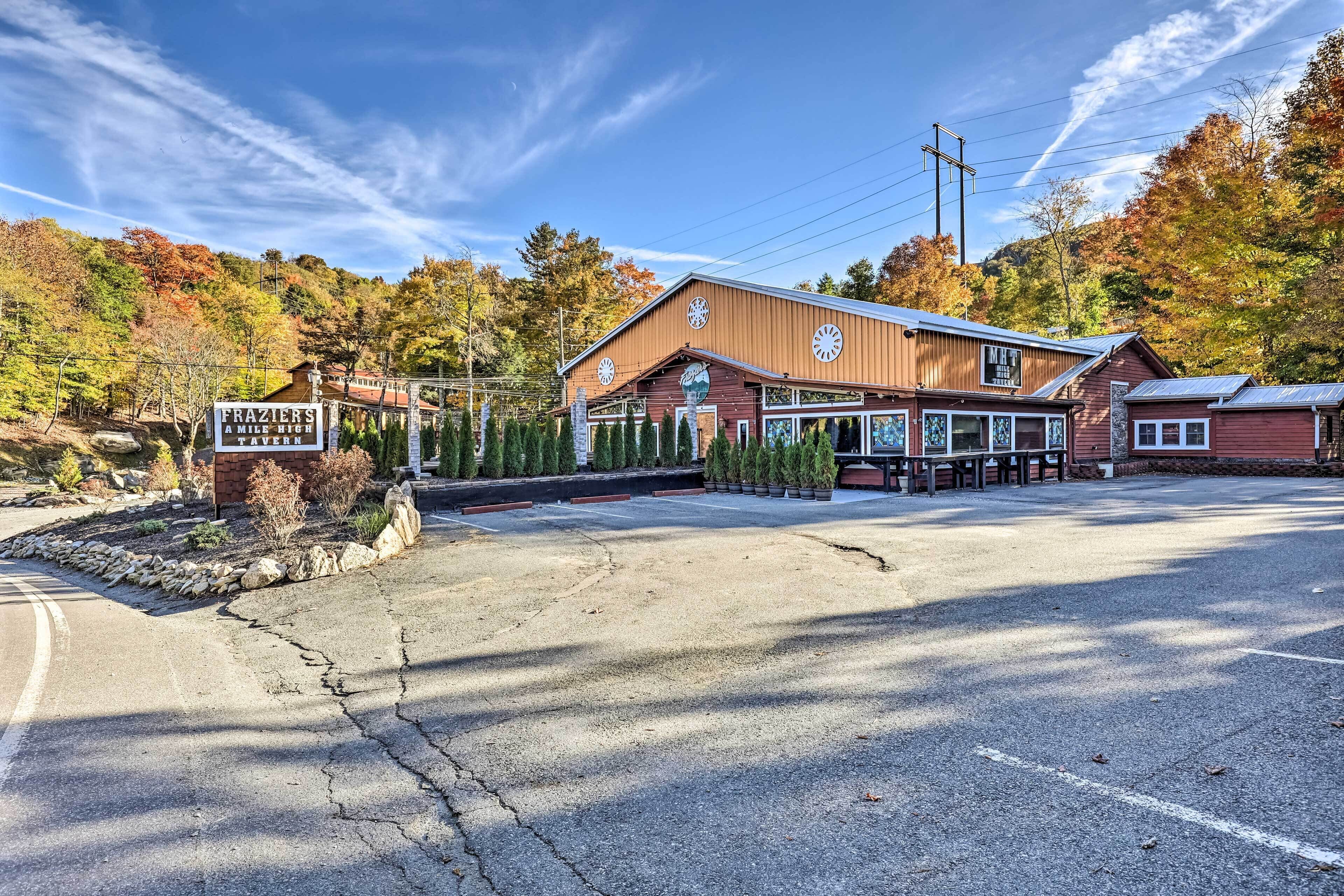 A rustic building with a sign reading "Frazier's A Mile High Tavern."