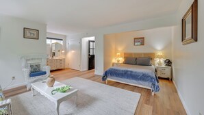 A bedroom with a bed, bedside tables, a nightstand, a chair, a dresser, and a mirror. - Home 3 Mi to Main St Julian: Great for Groups! (Julian)