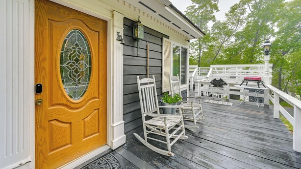 A wooden door with a glass panel, a porch with rocking chairs, and a white railing. - Home 3 Mi to Main St Julian: Great for Groups! (Julian)