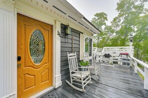 A wooden door with a glass panel, a porch with rocking chairs, and a white railing. - Home 3 Mi to Main St Julian: Great for Groups! (Julian)