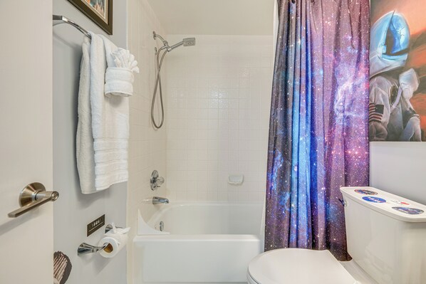 A bathroom with a shower, toilet, and bathtub. - Pool Access: Beachfront Condo in Cape Canaveral! (Cape Canaveral)