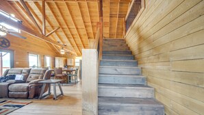 A wooden interior with a staircase, a sofa, and a dining area. - Pet-friendly Hideaway 13 Mi to Leakey (Leakey)