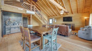 A spacious living area with a wooden ceiling, a dining table with chairs, a sofa, and a television. - Pet-friendly Hideaway 13 Mi to Leakey (Leakey)