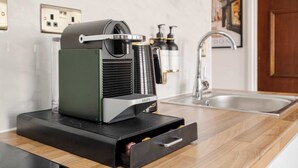 A compact coffee machine on a kitchen counter with a drawer below it. - Stunning Apartment in the ❤️ of Mayfair ❄️ Air Conditioning | Sleeps 5 (Greater London)