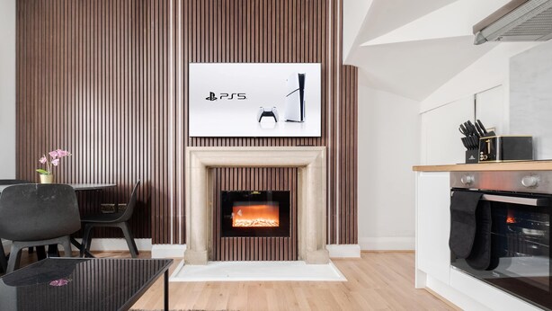 A modern living room with a fireplace, a dining area, and a kitchen. - Stunning Apartment in the ❤️ of Mayfair ❄️ Air Conditioning | Sleeps 5 (Greater London)