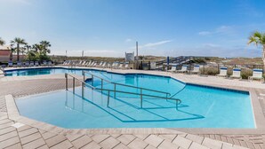 A swimming pool with a diving board, lounge chairs, and a paved deck. - Phoenix East 2 2074 2 Bedroom Condo (Orange Beach)