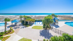 A resort with a swimming pool, beach views, and a gazebo.
