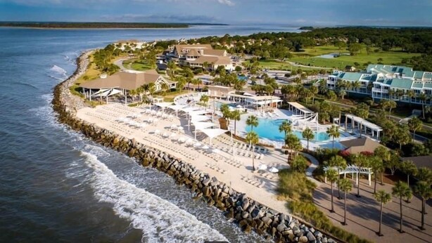 A coastal resort with a large pool, beach, and ocean views.