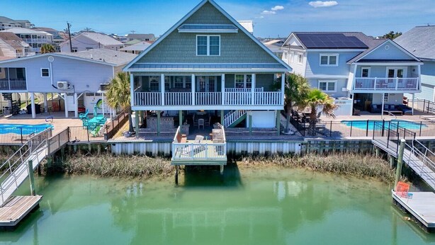 A waterfront house with a dock and a swimming pool. - A Lady's Place (North Myrtle Beach)