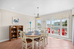 A dining area with a round table, six chairs, and a pendant light. - Waterfront Retreat 1 Block from the Beach Sleeps 8 (North Myrtle Beach)