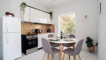 Apartment, 2 Bedrooms, Garden View | Private kitchen | High chair, cookware/dishes/utensils