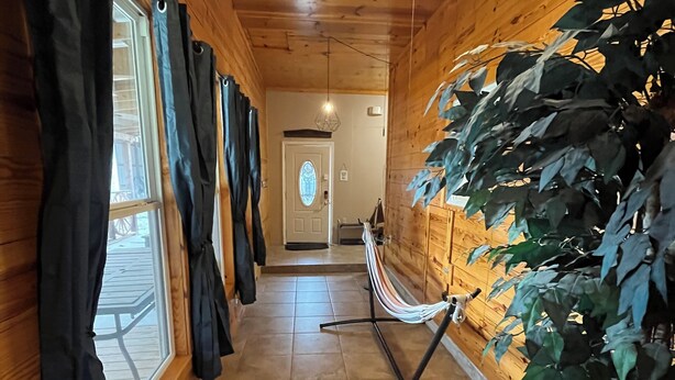 A wooden hallway with a ceiling fan, a hammock, and a potted plant. - Spacious and comfortable 3-bedroom house in peaceful Somerset, KY. All amenities (Somerset)