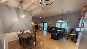 A spacious living area with a dining table, a sofa, and a staircase. - Spacious and comfortable 3-bedroom house in peaceful Somerset, KY. All amenities (Somerset)