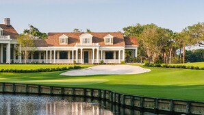 A large, elegant building with a formal front porch and a well-maintained lawn. - Fairway Oaks Villa! Lagoon views! Short 5-7 minute stroll to the beach! (Kiawah Island)