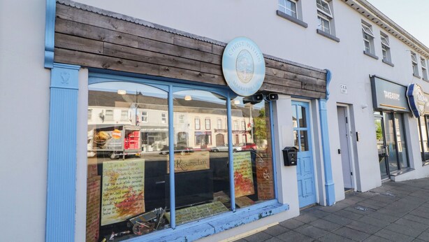 A storefront with a blue awning and a sign reading "Christ Within Markethill."