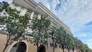 A multi-story building with a modern architectural design, featuring balconies and large windows. - 4BNB - Porta Portese Cozy Apartment (Rome)