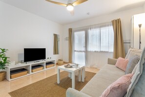 TV, table tennis - Casa Loleta Vacation Apartment with Shared Pool, Private Terrace, and Wi-Fi (Corralejo)