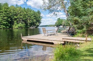 A wooden dock extending into a calm lake, surrounded by dense forest. - Talbot - Pineview - Two Bedroom Cottage, Sleeps 5 (Kawartha Lakes)
