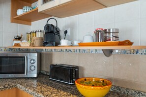 Fridge, microwave, stovetop, coffee/tea maker