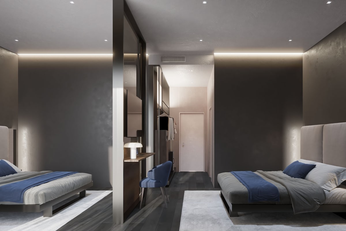 A modern hotel room with two beds, a desk, and a chair.