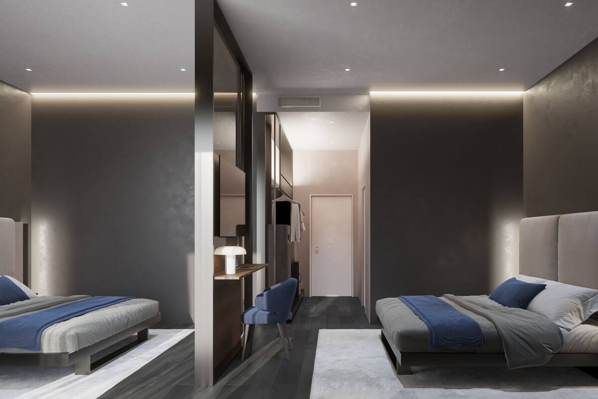 A modern hotel room with two beds, a desk, and a chair.