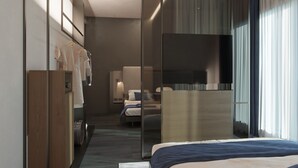 A modern hotel room with a bed, a desk, a wardrobe, and a large mirror. - Kira Suites Hotel Milano (Milan)
