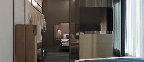 Una habitación de hotel moderna con una cama, un escritorio, un armario y un espejo grande.