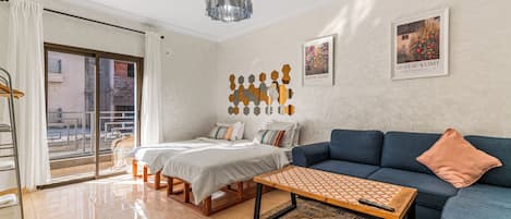 A modern living room with a bed, sofa, and a coffee table.