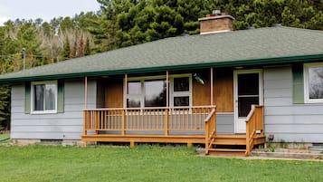 A single-story house with a front porch and a chimney.