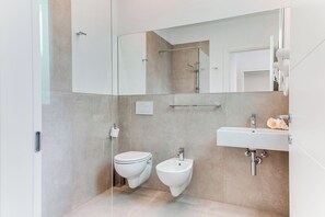 Chuveiro, secador de cabelo, bidê, toalhas de banho