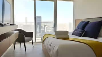 Relax in a spacious room with a large bed, flat-screen TV, and city view.